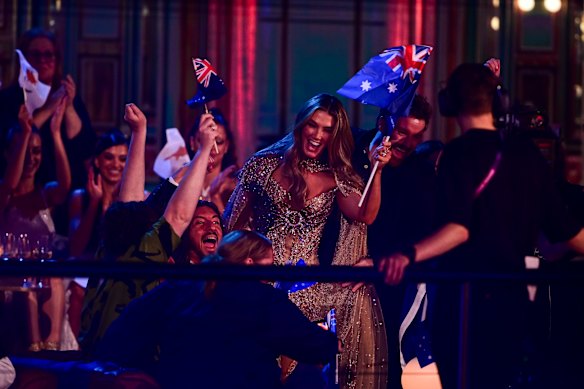 Goodrem waves the Australian flag alongside fans at Eurovision in Vienna.