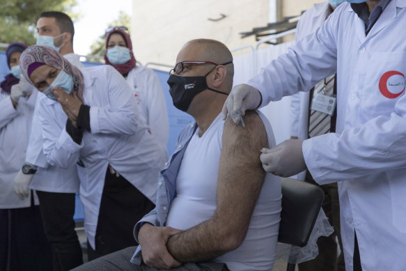A medic administers a Moderna COVID-19 vaccine to a colleague in Bethlehem last week.