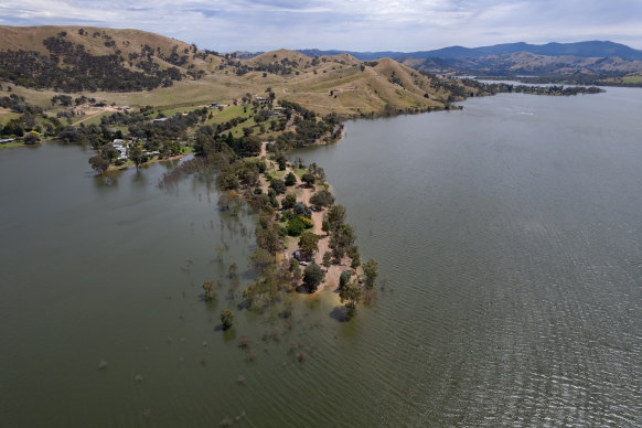 In a stark contrast to 15 years ago, Lake Eildon has swallowed some young gum trees and the water is just metres from some homes.