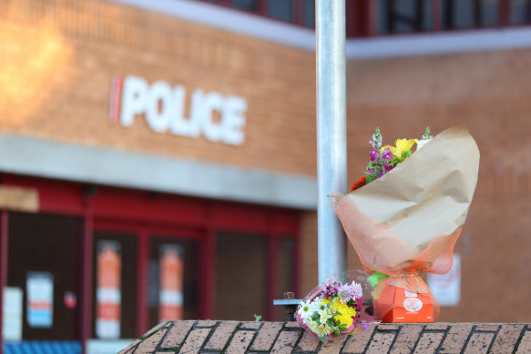 Flowers are left outside the Henderson Police station after an officer was killed on Friday.