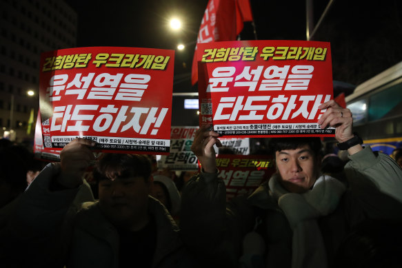 People gathered outside the National Assembly building in Seoul protesting the martial law declaration.