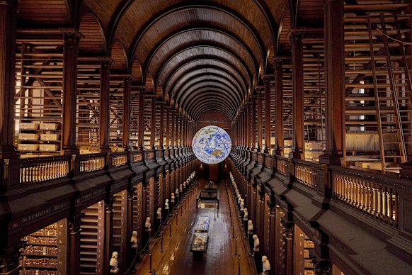 The Trinity College Long Room, with “Gaia” in the distance.