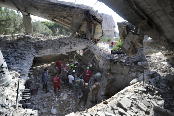 Rescue workers search for victims on a hotel-turned-shelter for displaced people hit by an Israeli airstrike, in Wardaniyeh, south Lebanon, on Wednesday.