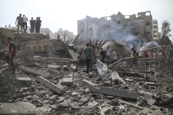 Palestinians inspect damage to a mosque and their homes in Gaza City following Israeli air strikes on Monday.