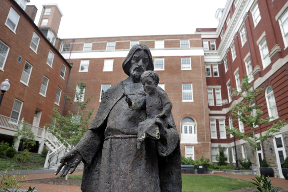 A Jesuit statue is seen in front of Freedom Hall at Georgetown University. In 2016, the university moved to give admission preference to descendants of slaves owned by the Maryland Jesuits as part of its effort to atone for profiting from salve sales.