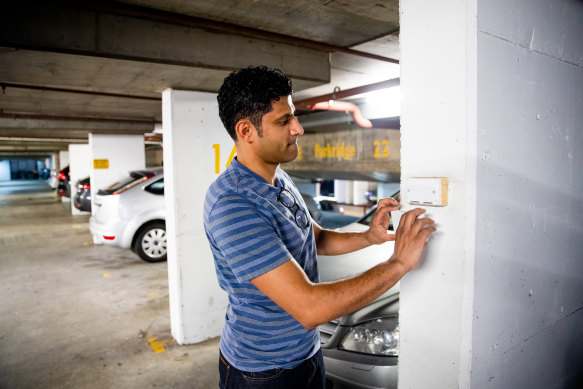 Dr Gupta in his carpark with the power point that was covered so he couldn’t charge his electric vehicle. 