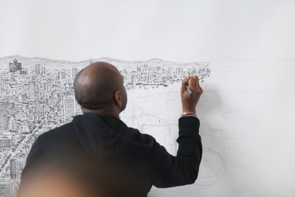Stephen Wiltshire drawing a large panorama of Mexico City from memory in 2016.