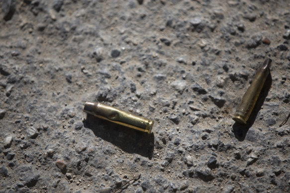 Ammunition casings lay on the ground near the entrance to the President’s residence.