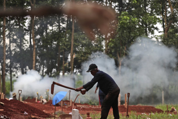 A gravedigger prepares a grave for a COVID-19 victim at Cipenjo cemetery in Bogor, West Java on Wednesday.
