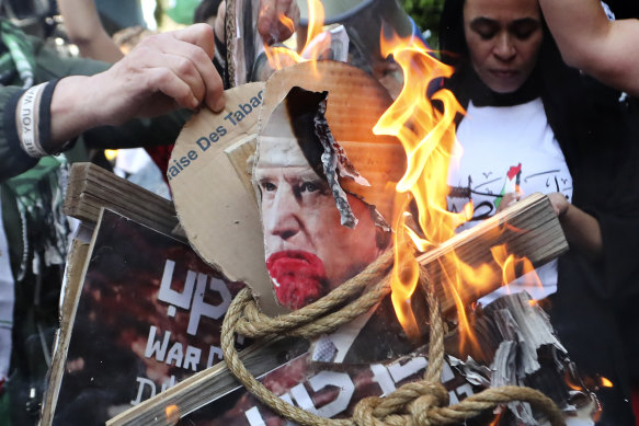 Protesters burn pictures of US President Joe Biden at the Palestinian refugee camp of Ein el-Hilweh in south Lebanon.