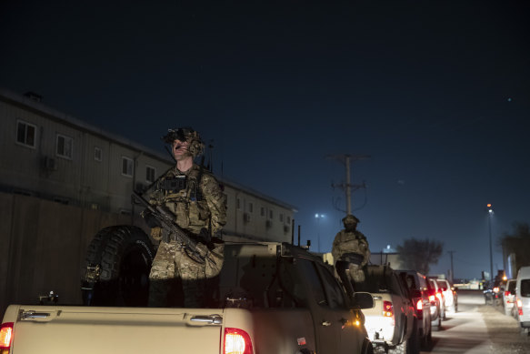 Soldiers stand guard in the motorcade for then president Donald Trump when he visited Afghanistan in 2019.