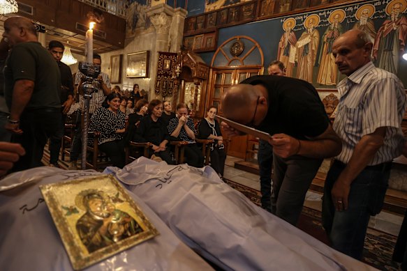 Catholics attend a mass for those who lost their lives in the Israeli strike on the Holy Family Church in Gaza.