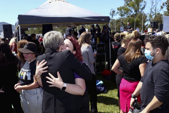 Tanya Plibersek hugs Saxon Mullins at the March 4 Justice protest.