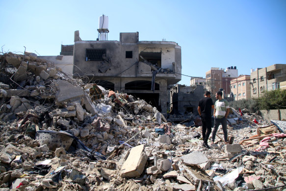 Palestinian citizens inspect damage to their homes caused by Israeli airstrikes on October 15, 2023 in Khan Younis, Gaza. 