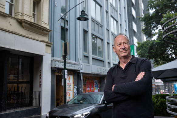 Resident Mark Baker in front of Melbourne House, which has been saved from demolition. 