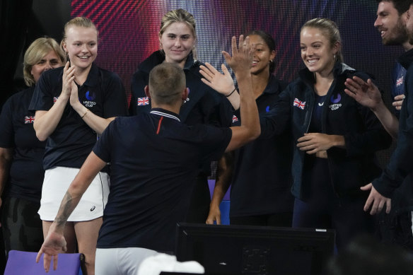 Dan Evans celebrates with his teammates after defeating Spain’s Albert Ramos-Vinolas in their Group D match in Sydney on Sunday night.