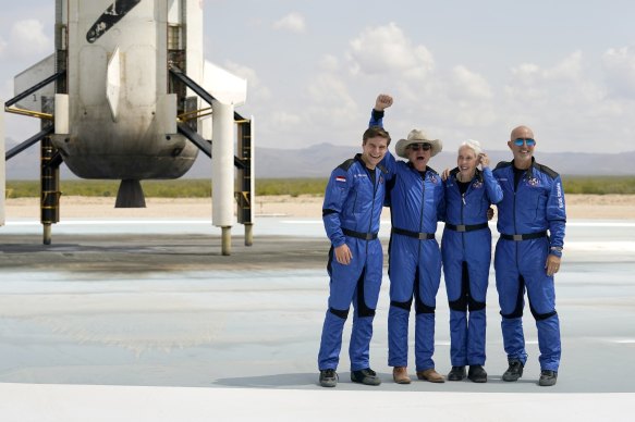 Oliver Daemen, from left, Jeff Bezos, founder of Amazon and space tourism company Blue Origin, Wally Funk and Bezos’ brother Mark pose for photos in front of the Blue Origin New Shepard rocket on return to Earth.