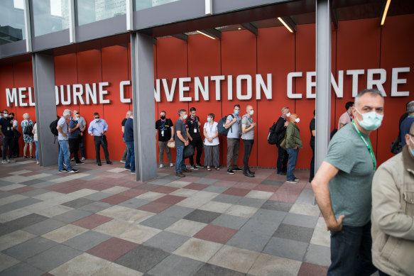 People line up for hotel quarantine training at Melbourne Convention Centre on Saturday.