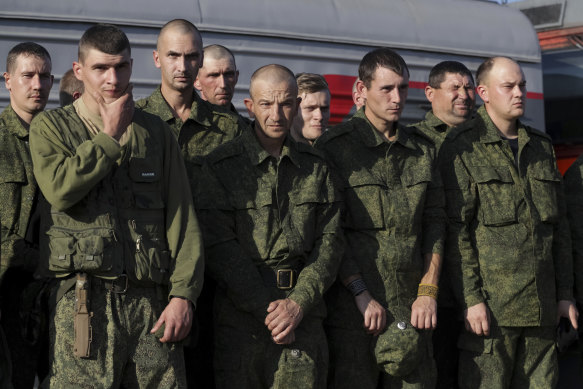Russian recruits stand waiting to take a train at a railway station in Prudboi, Volgograd region of Russia.