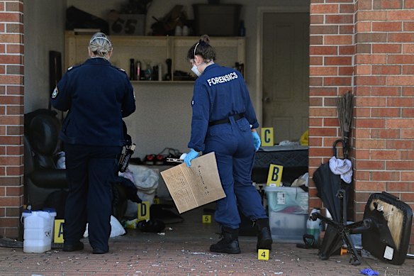 NSW police and forensic officers process the crime scene at Canley Heights.