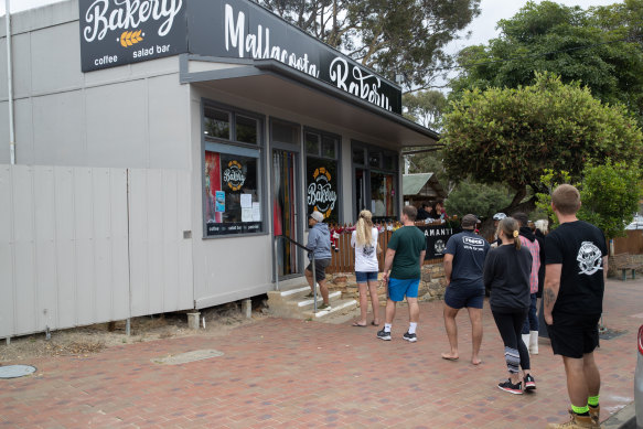 A queue for service at the Mallacoota Bakery on Friday.