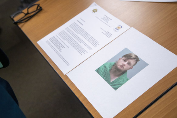 An image of the accused, Robert Aaron Long, is displayed near a press release provided by the Cherokee County Sheriff’s Office.