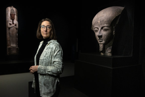 Marie Vandenbeusch, a curator from the British Museum, with a fragment of the sarcophagus lid of Pharaoh Ramses V.