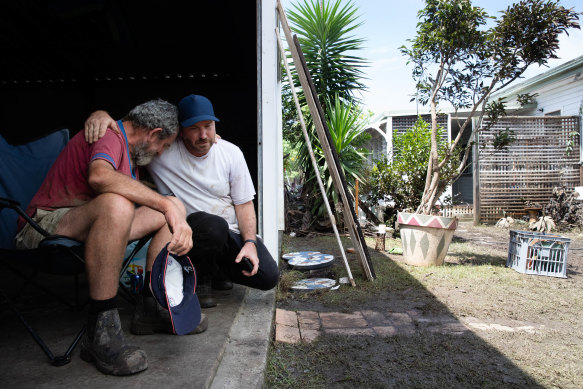 Father and son, Bruno and Mitchell Temporini outside their ruined home. 