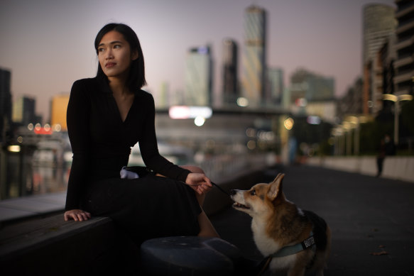 Lia Mills with her dog Butter on Wednesday. She doesn’t know when she will see her mother, who is in Indonesia, again. 