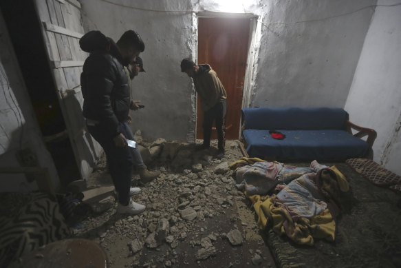 People check a house damaged by an Israeli airstrike, in Qalili village, south Lebanon, early on Friday.