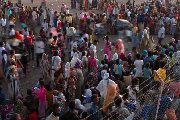 Ethiopian refugees wait in Hamdayet, Sudan for supplies from the UN Refugee Agency, in December. 
