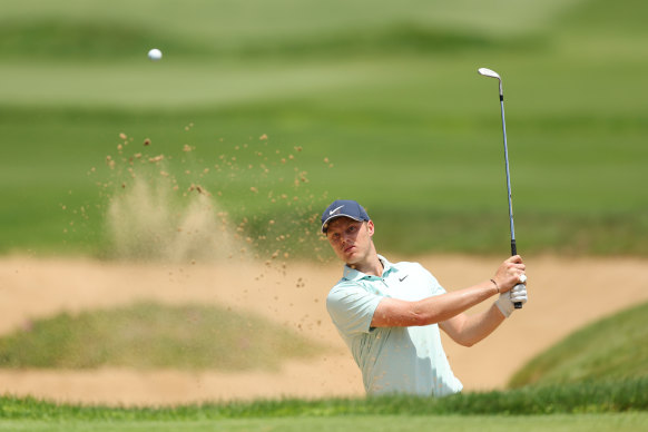 Cameron Davis hits out of a bunker on his way to a 63 at The Lakes.