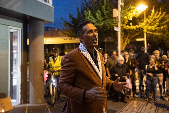 Berhan Ahmed addresses the crowd at the vigil.