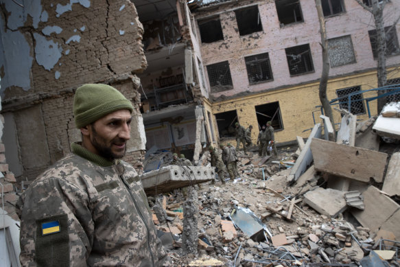 Military personnel on Tuesday, March 8, 2022, at a barracks used by Ukrainian airborne troops  that was attacked by Russian forces the day before in Mykolaiv, Ukraine.
