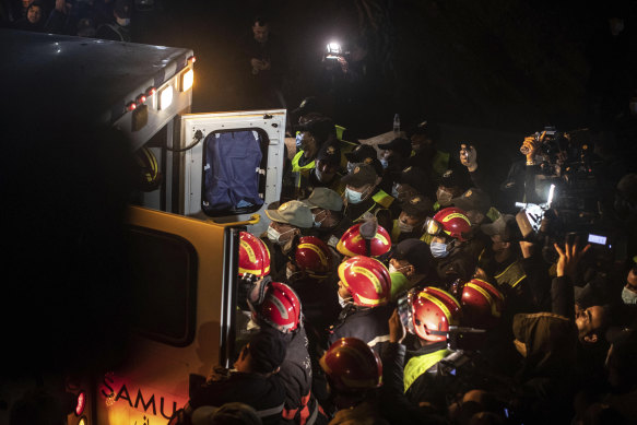 Rescue workers carry the body of 5-year-old Rayan and place it in an ambulance after it was retrieved from a hole  in the village of Ighran in Morocco.