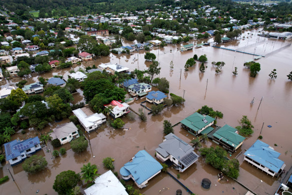 Stay or go? Lismore homes surrounded by floodwater in late March this year. 