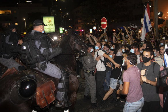 Israeli demonstrators scuffle with police officers during a protest in Tel Aviv on Saturday.