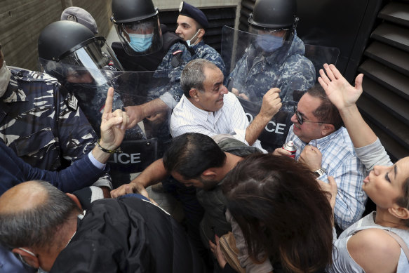Bank customers scuffle with riot police as they try to storm a Beirut bank in November.