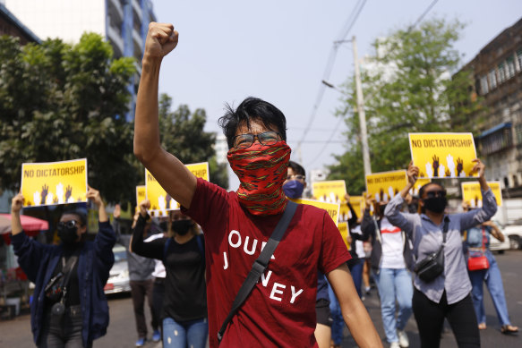 Anti-coup protesters gesture during a march in Yangon, Myanmar. 