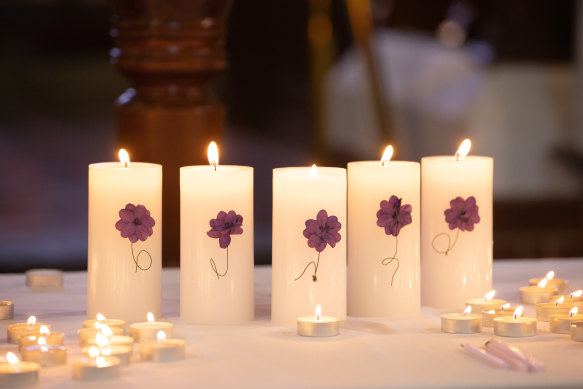 Five candles honouring the deceased victims. 