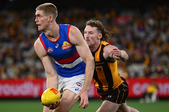 Josh Weddle of the Hawks chases Tim English.