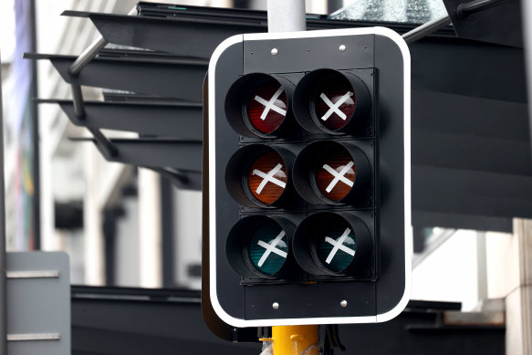 A traffic light is taped up along a street at Newmarket, Auckland, on Thursday. The city remains in lockdown.