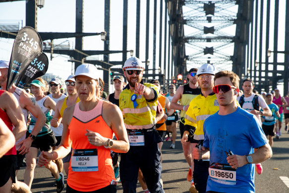 Mine over matter: Sydney Marathon runners, some in hi-vis, on the Harbour Bridge.