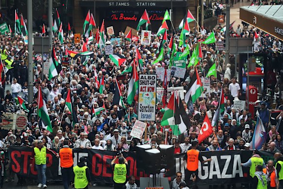 Demonstrators march through the CBD on Sunday.