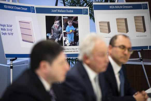 Placards showing images of two-year-old Jozef Dudek and IKEA's Malm dressers are displayed during a news conference in Philadelphia on Monday.