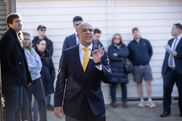 Ray White Oakleigh auctioneer Robert Cincotta takes bids during the Northcote auction.