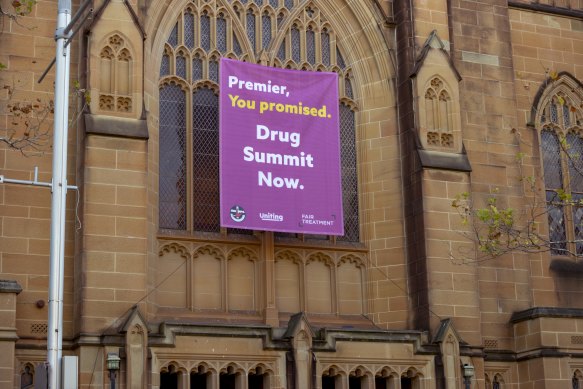 A banner demanding a drug summit is displayed at St Stephen’s Uniting Church, opposite the NSW Parliament.