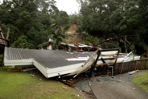 A destroyed house at the bottom of a large landslide in Auckland.