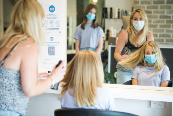 Newport hairdresser Kylie Grey with her daughter, Jersey Grey, and their friend, Zienna Sidoti, looking on.