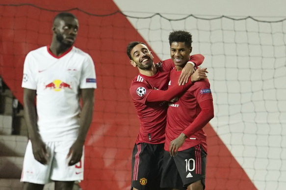 Bruno Fernandes and Marcus Rashford celebrate one of United's five goals against Leipzig.